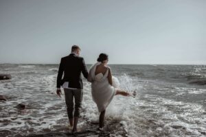 COUPLE WALKING ON BEACH